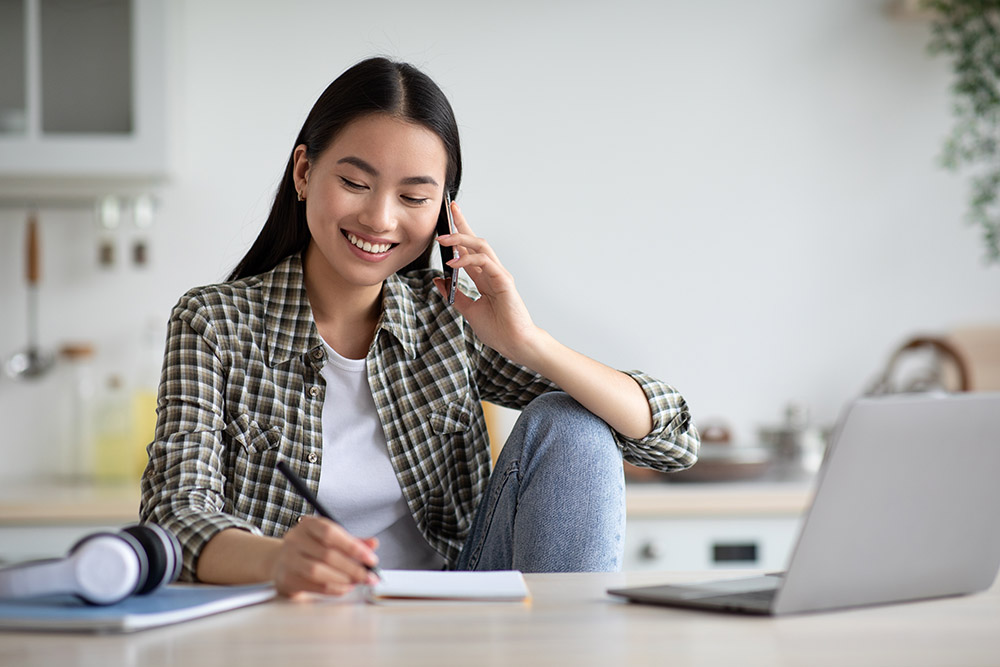 woman on phone at computer